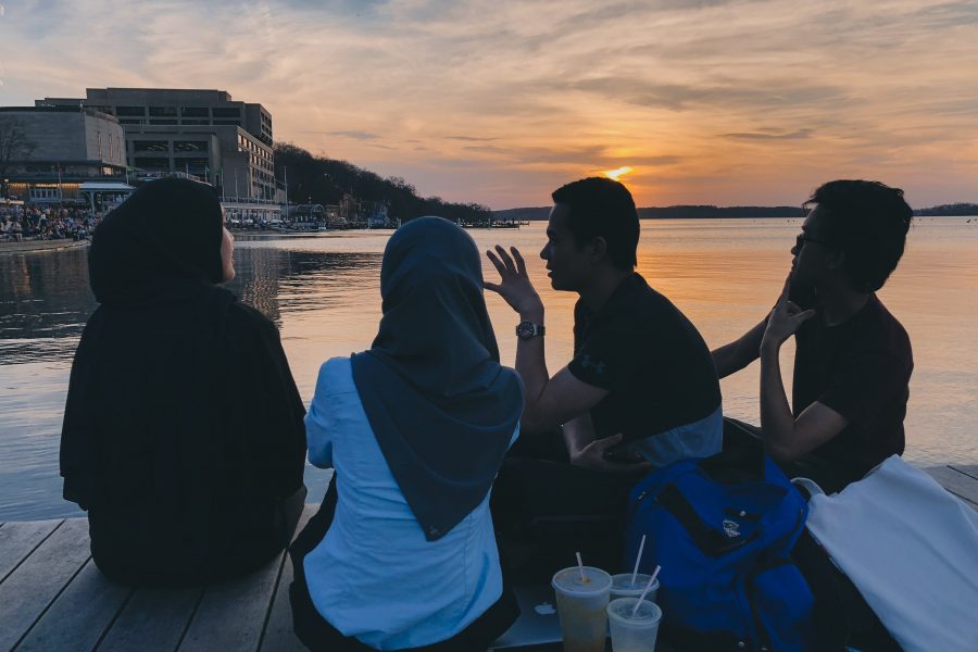 Students sitting by the lake