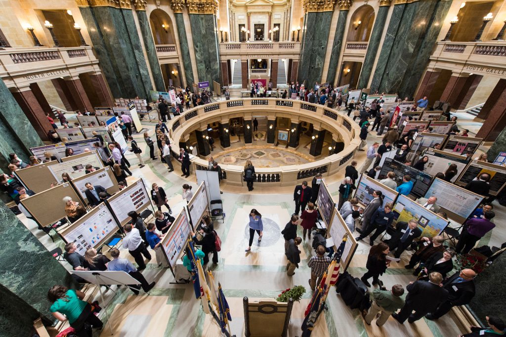 People and undergraduate research displays fill the Wisconsin State Capitol during Posters in the Rotunda on April 22, 2015.